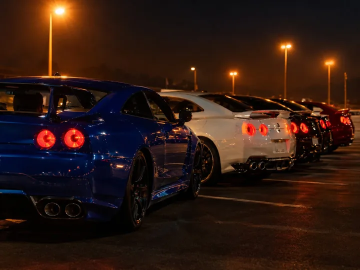 Tuned sports cars in a parking area at night