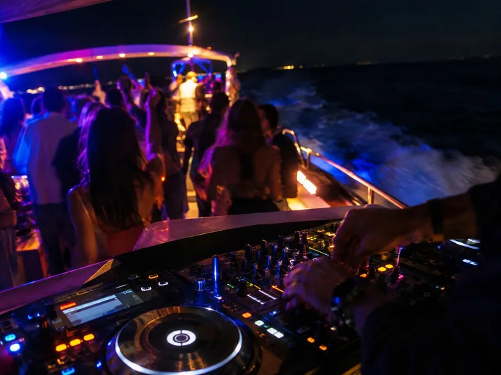 Colored party lights on a boat deck at night