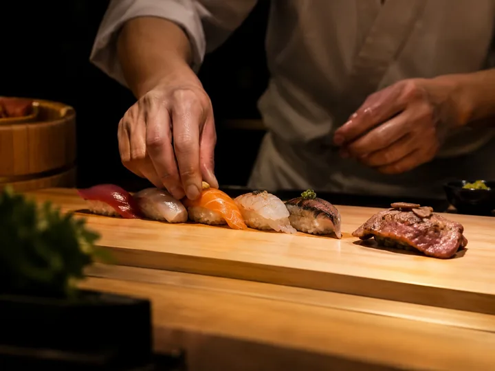 Pieces of nigiri sushi on a wooden counter