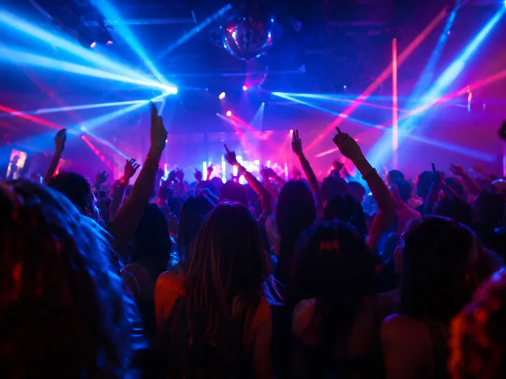 A neon-lit nightclub dance floor