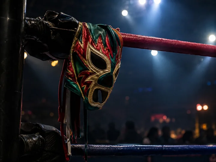 A colorful wrestling mask on a ringside rope