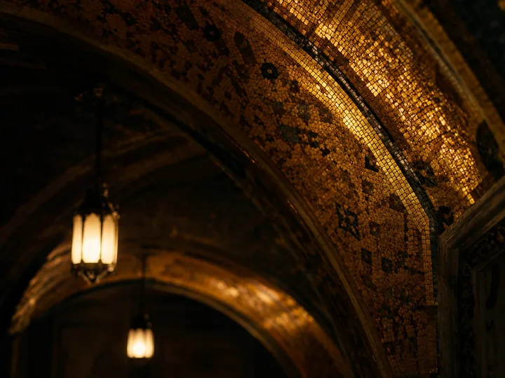 Gold mosaic glinting in a dim church interior