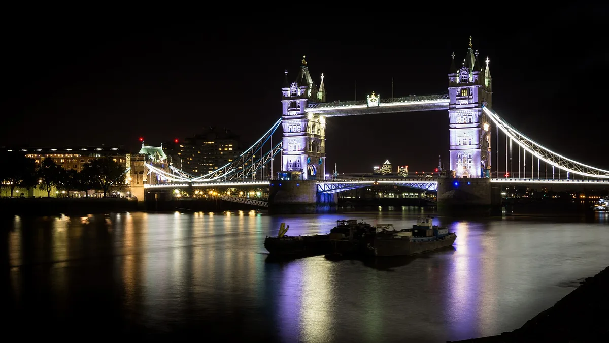 Tower Bridge lit at night over the River Thames in London