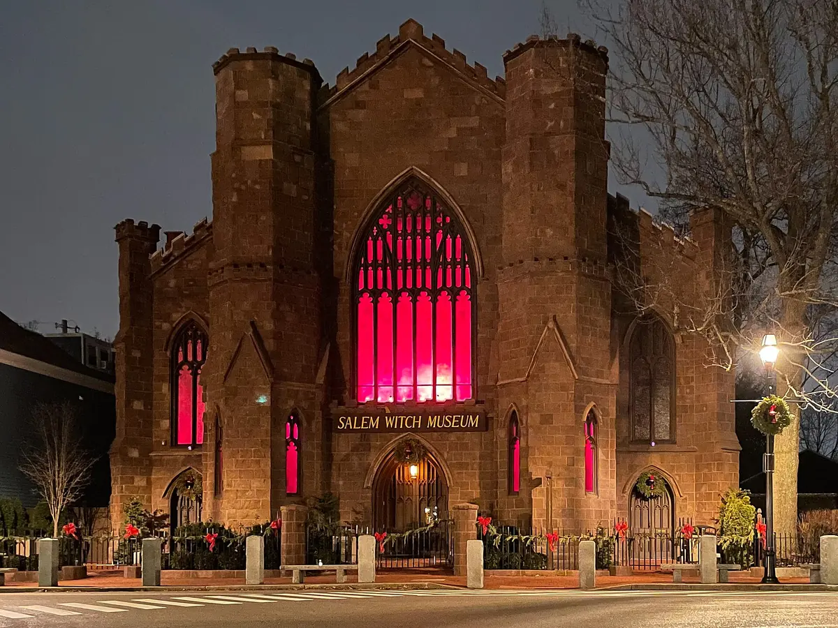 The Salem Witch Museum at dusk, its windows lit red