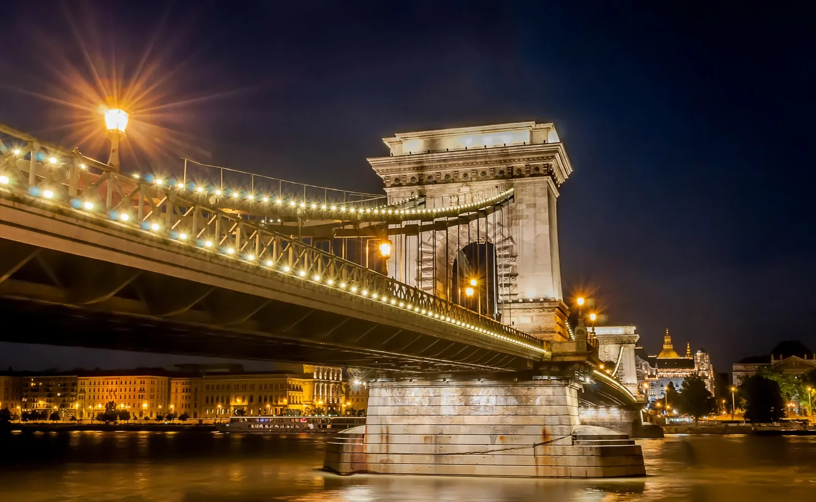 The Széchenyi Chain Bridge in Budapest lit at night over the Danube