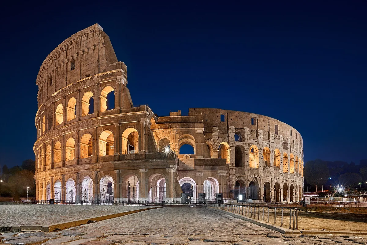 The Colosseum in Rome lit from inside at late blue hour