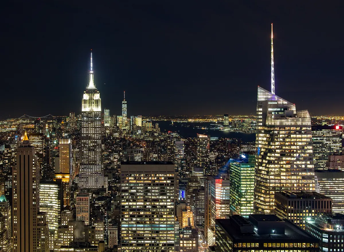 The Empire State Building lit at night above Midtown Manhattan, seen from Top of the Rock