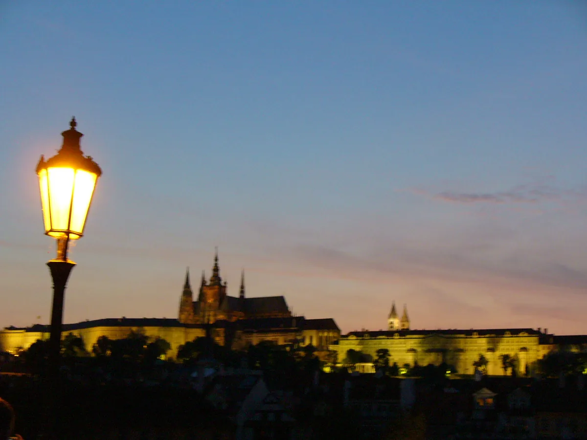 A street lamp and Prague Castle at sunset